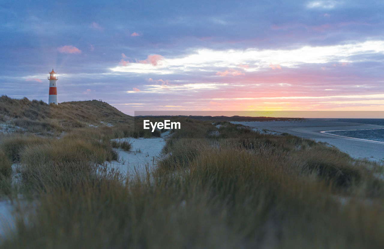 Scenic view of beach against sky during sunset