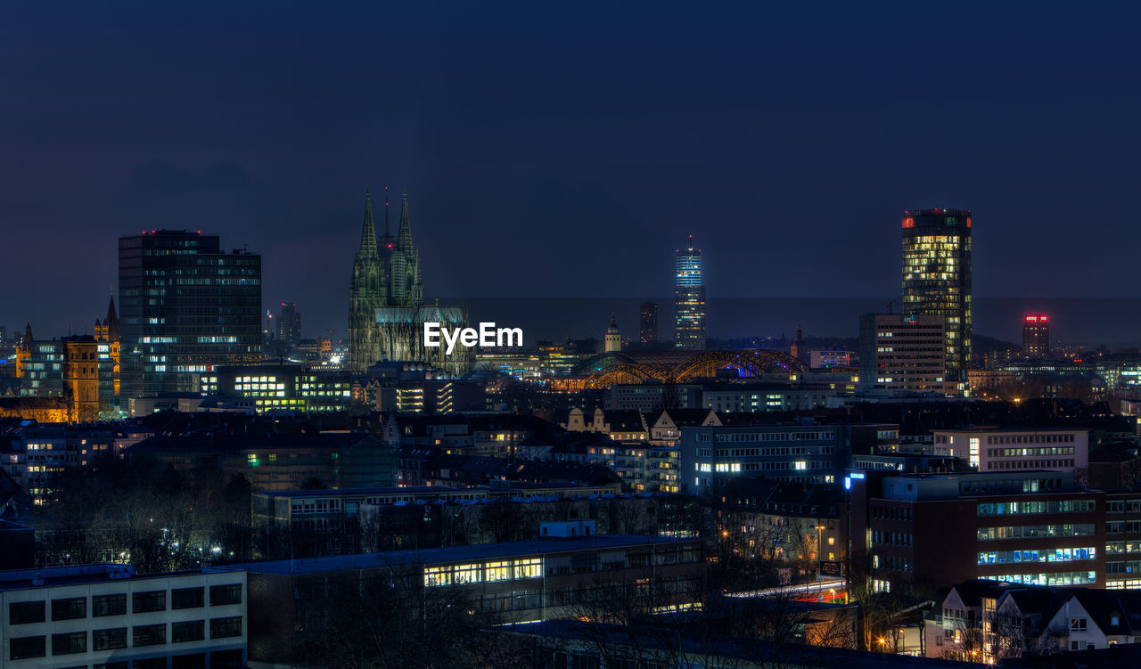 High angle view of illuminated buildings in city at night