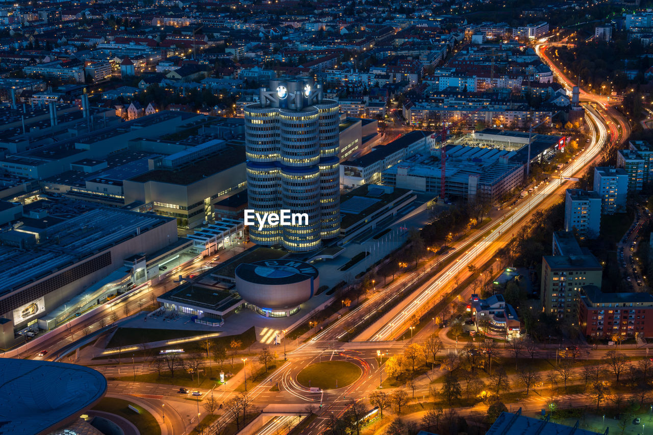 High angle view of illuminated city street and buildings at night