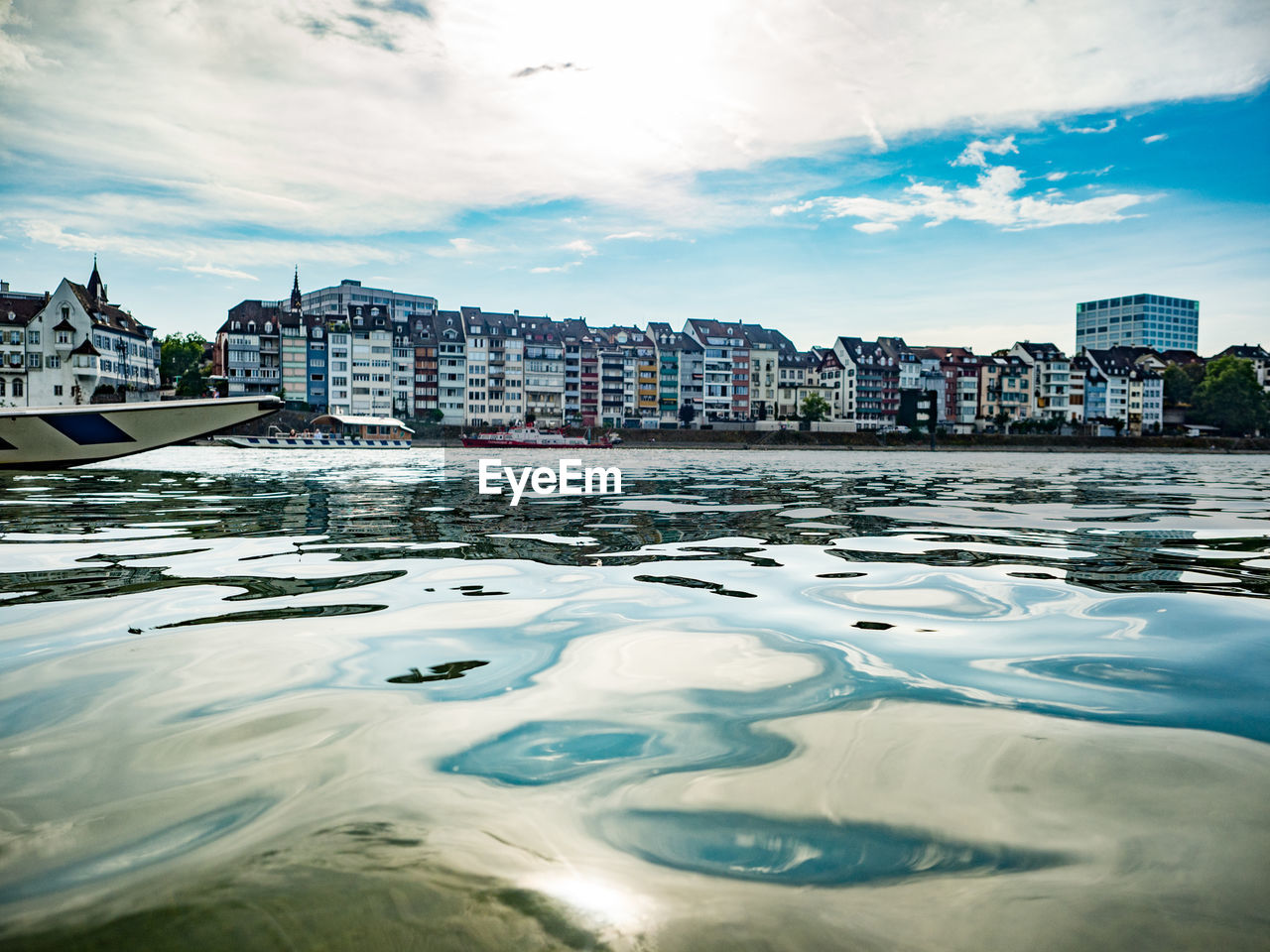 River by buildings in city against sky