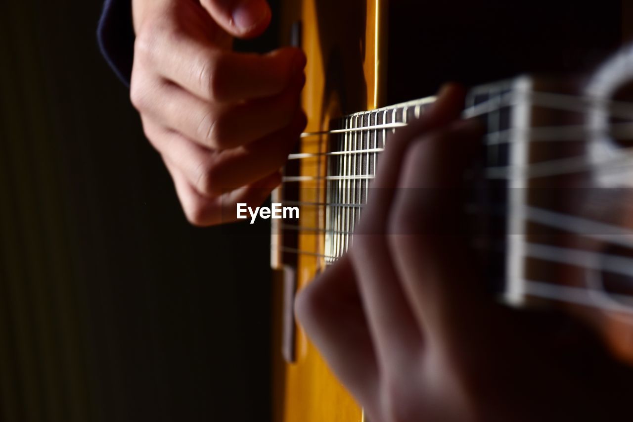 Youngster playing classic guitar. closeup of hands 