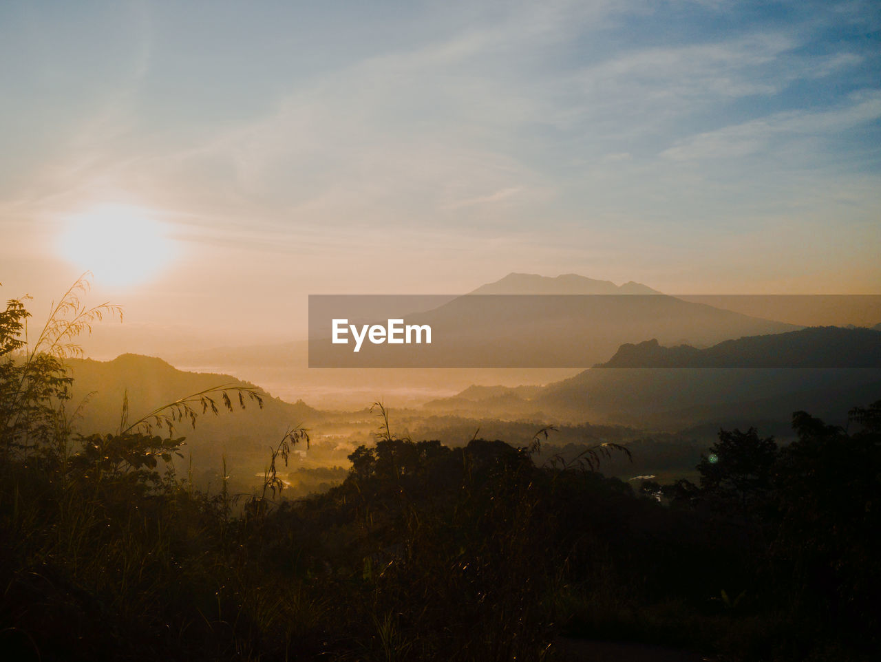 Scenic view of silhouette mountains against sky during sunset