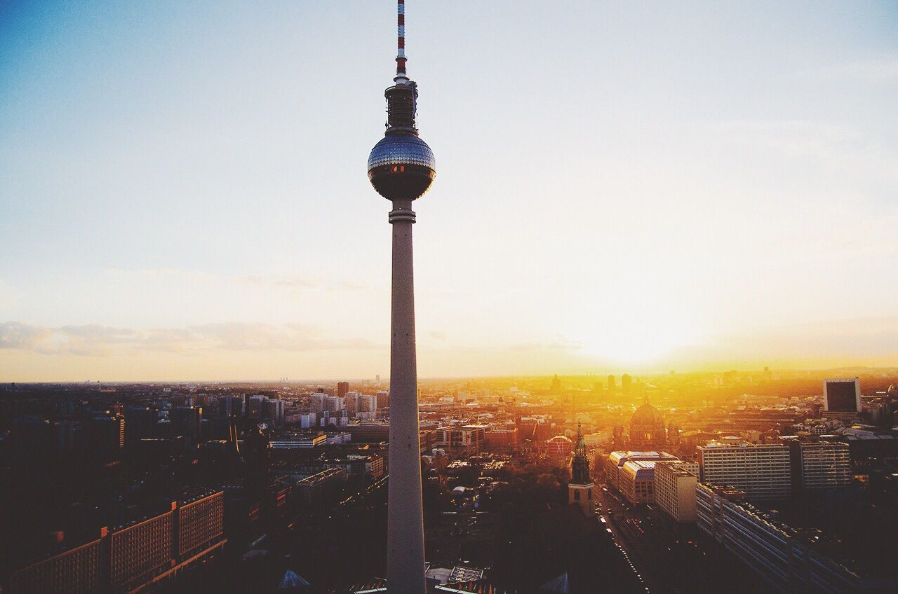 View of communications tower and cityscape at sunset