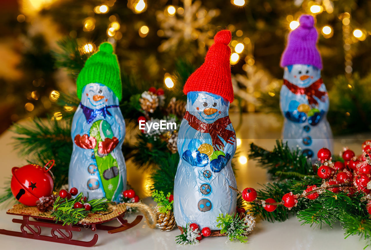 holiday, celebration, decoration, tree, christmas, christmas tree, christmas decoration, plant, tradition, winter, nature, no people, christmas ornament, human representation, christmas lights, snow, snowman, illuminated, interior design, representation, event, indoors, multi colored, male likeness, focus on foreground, cold temperature, gift, hat, figurine, religion