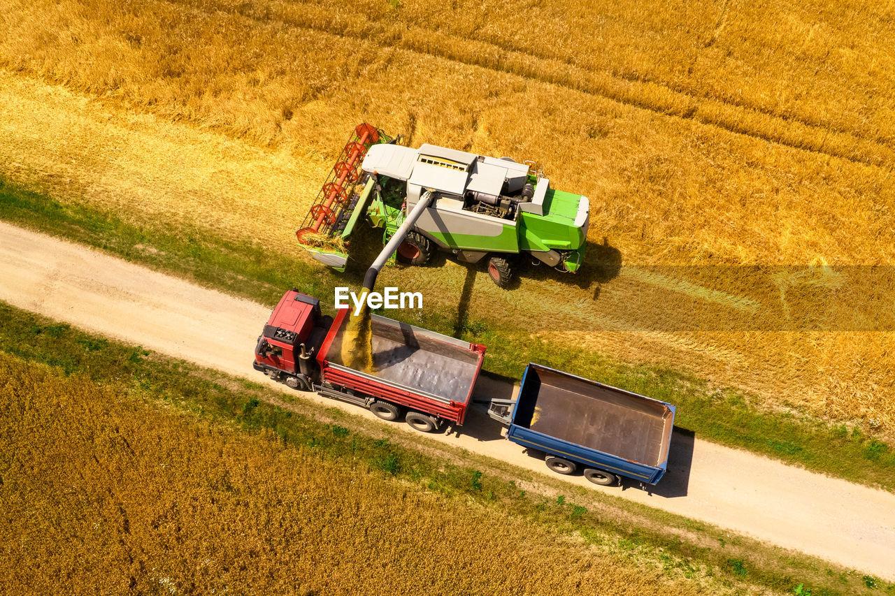 Aerial view of a combine harvester at work during harvest time. agricultural background.