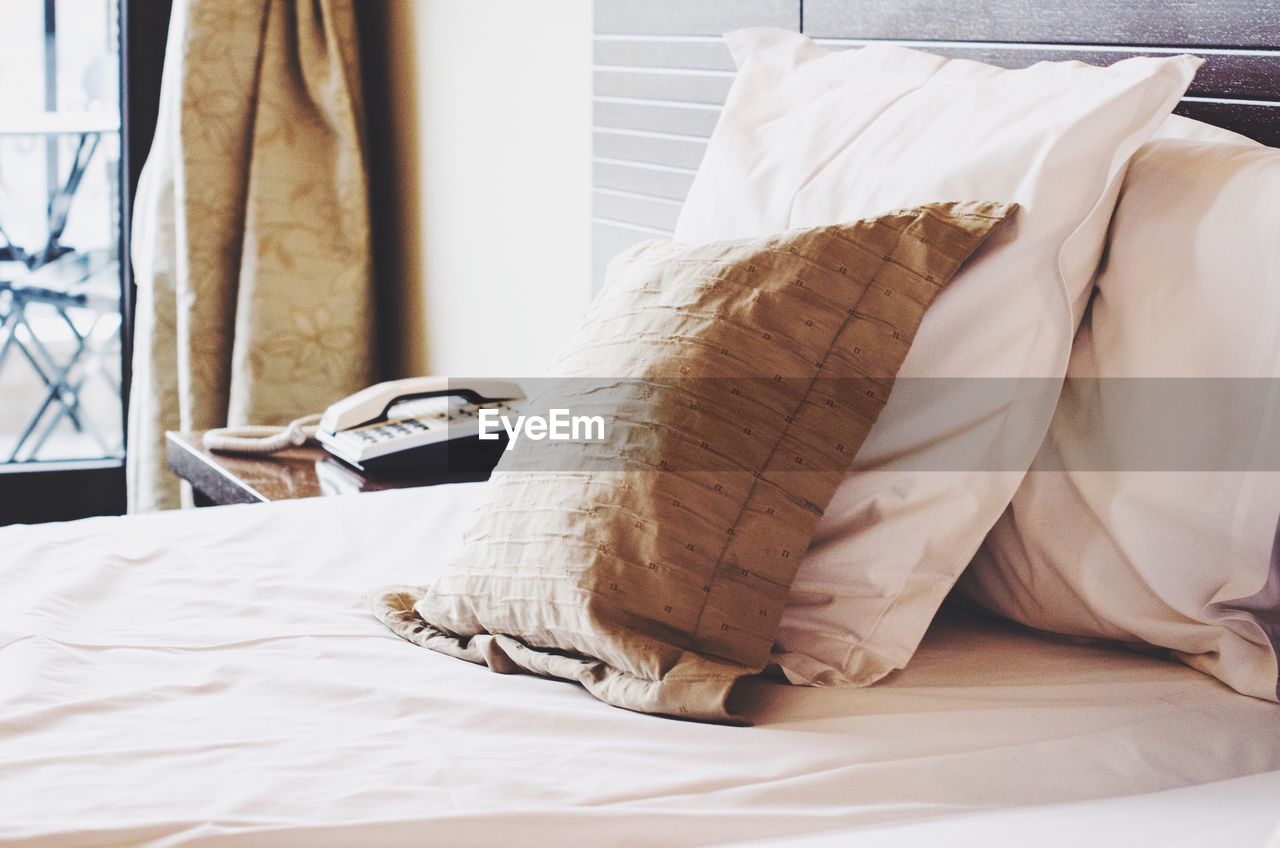 Close-up of pillows on bed