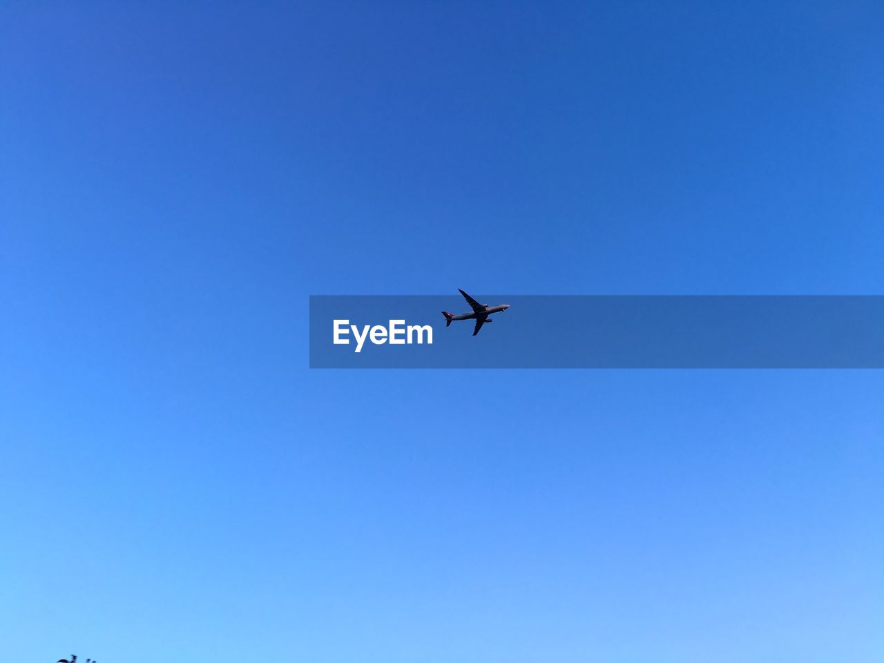 Low angle view of airplane flying against clear sky