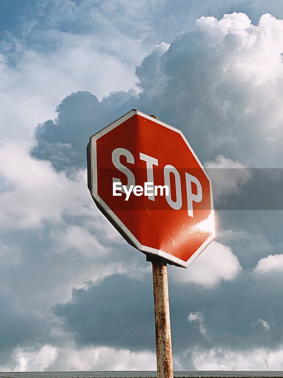 Low angle view of road sign against sky