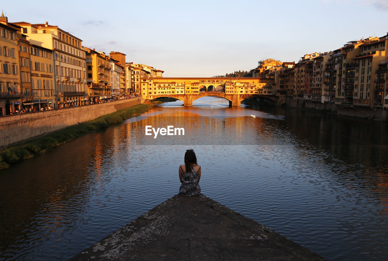 Rear view of woman looking at view of ponte vecchio