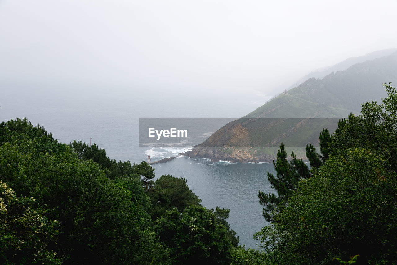 Scenic view of sea and mountains against sky