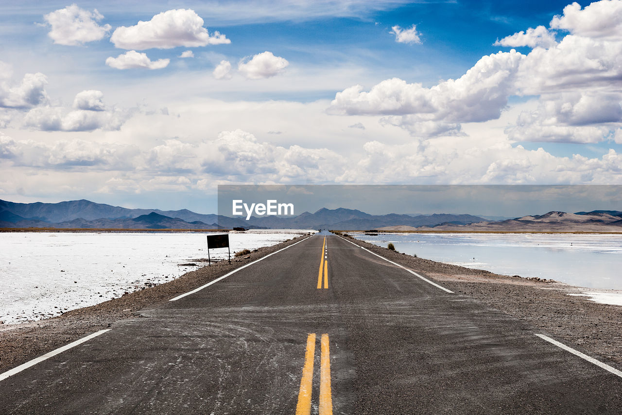 VIEW OF ROAD AGAINST CLOUDY SKY