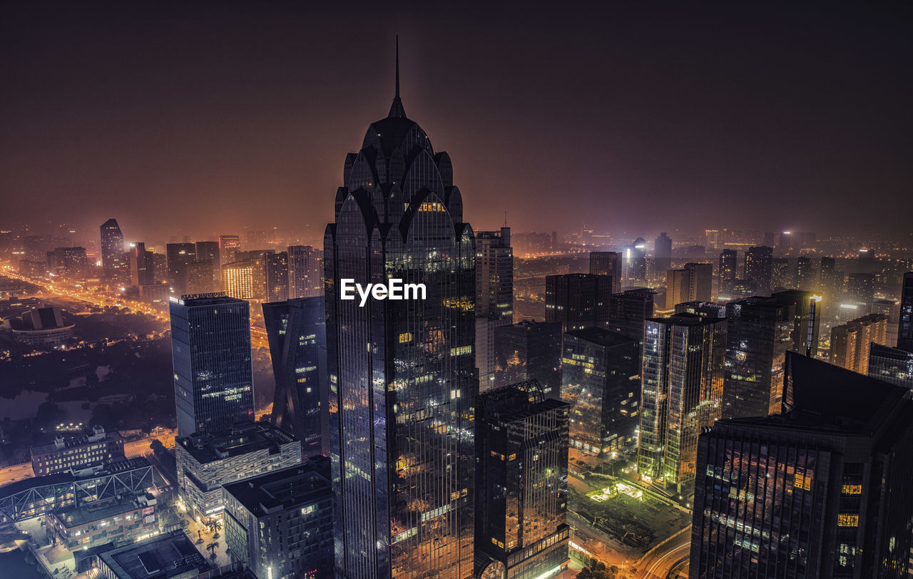 Aerial view of illuminated buildings in city at night