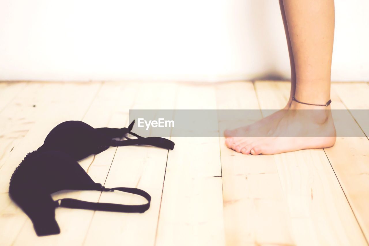 Barefoot girl getting undressed 
