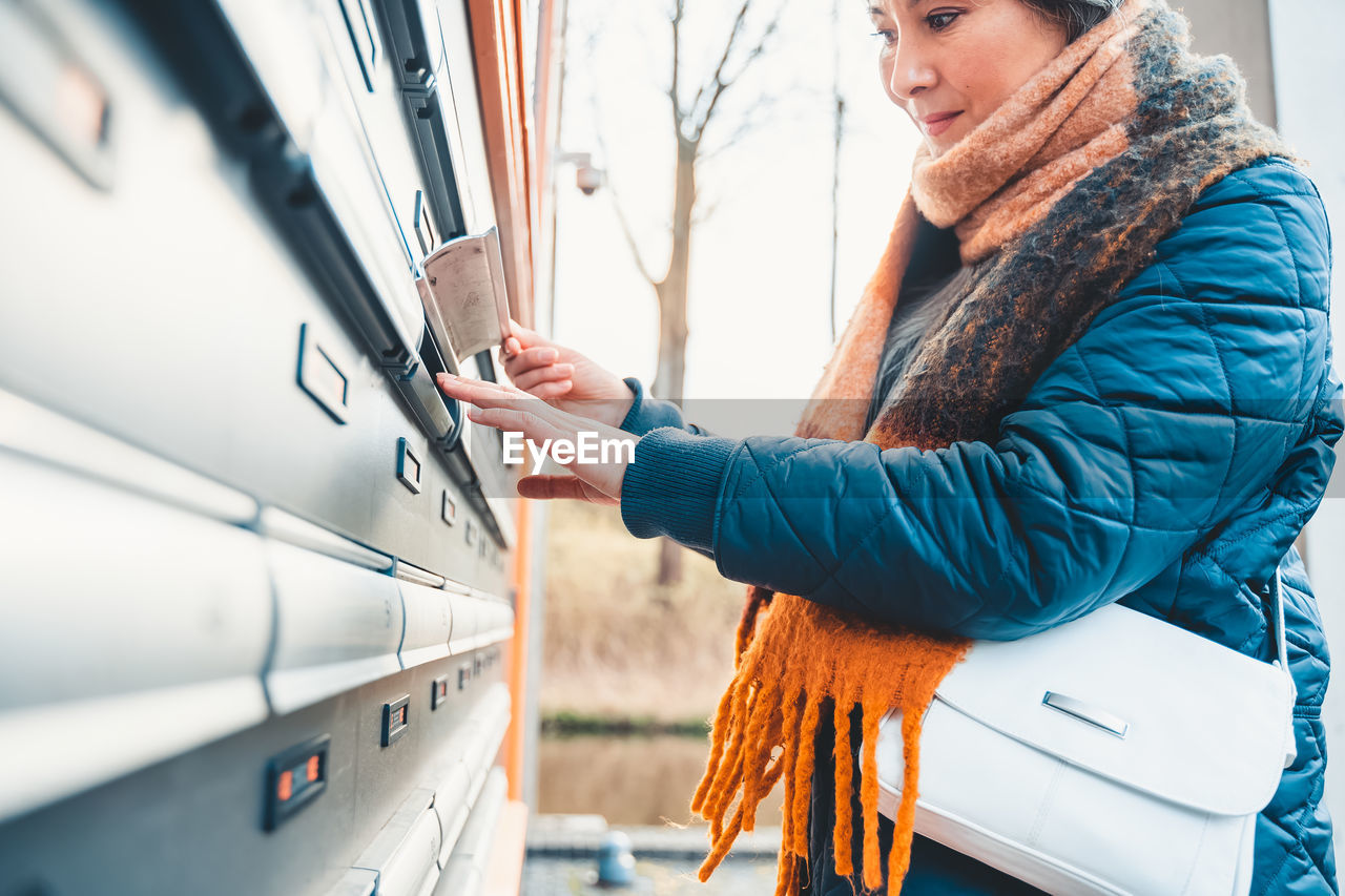 Mature woman checking mailbox