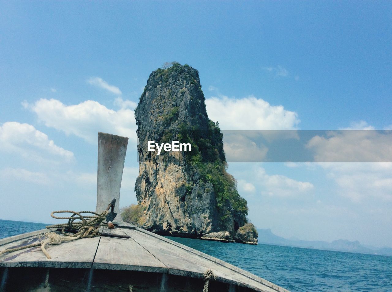 Close-up of boat with cliff in background