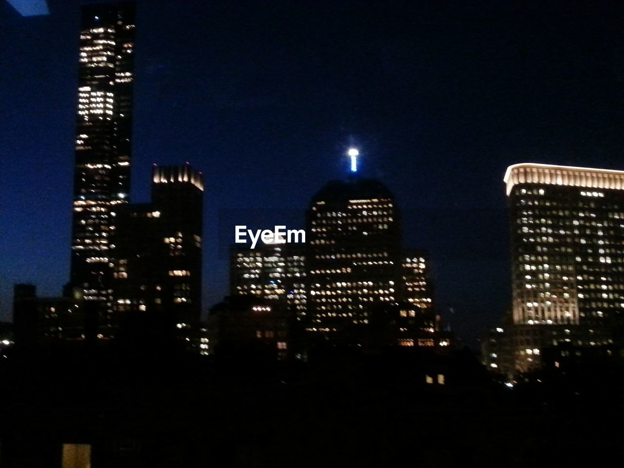 ILLUMINATED SKYSCRAPERS AT NIGHT