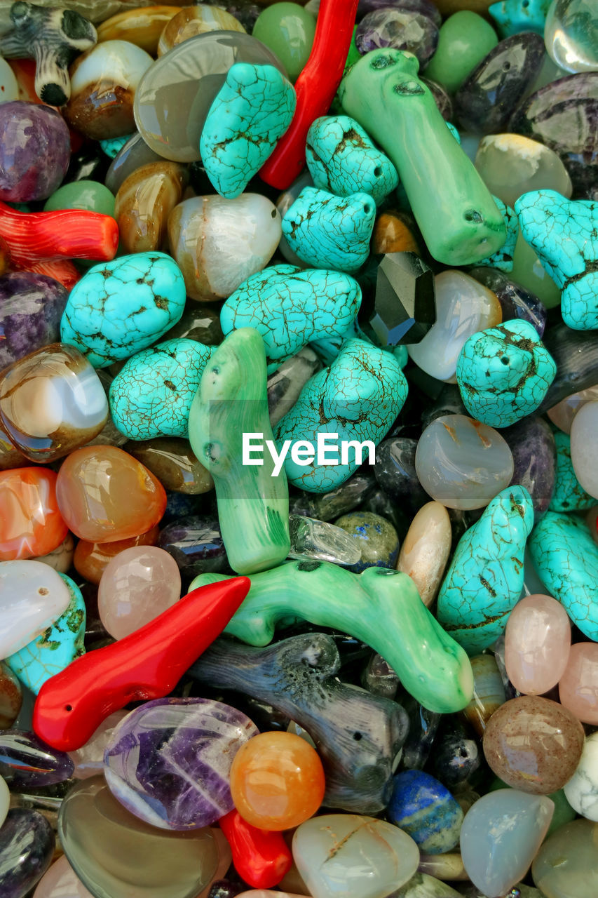 HIGH ANGLE VIEW OF MULTI COLORED CANDIES IN CONTAINER