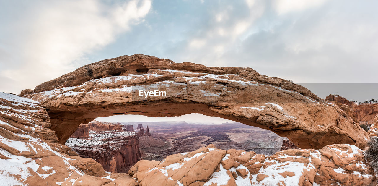 Rock formation against sky during winter