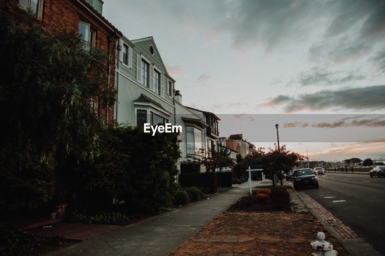 STREET AMIDST BUILDINGS AGAINST SKY