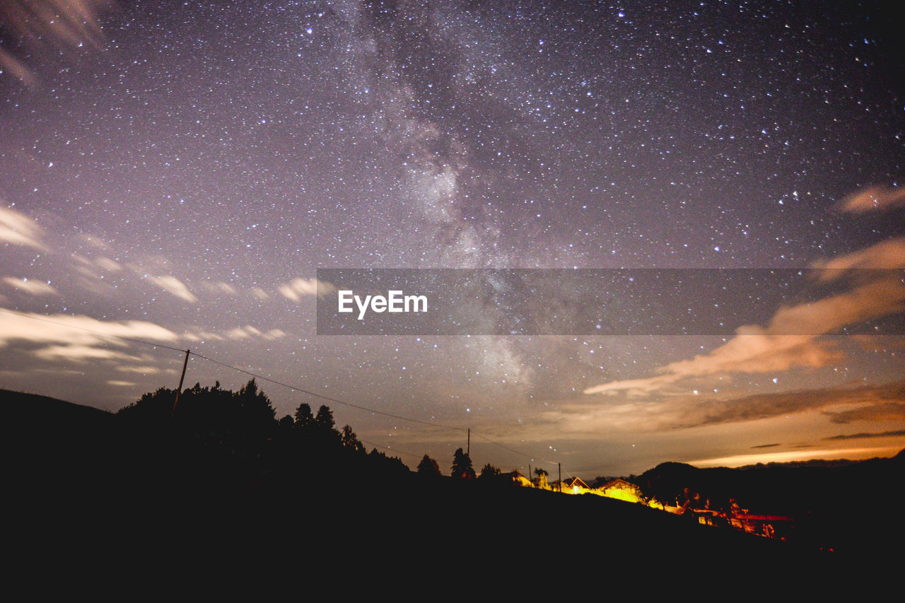 SCENIC VIEW OF SILHOUETTE TREES AGAINST SKY AT NIGHT