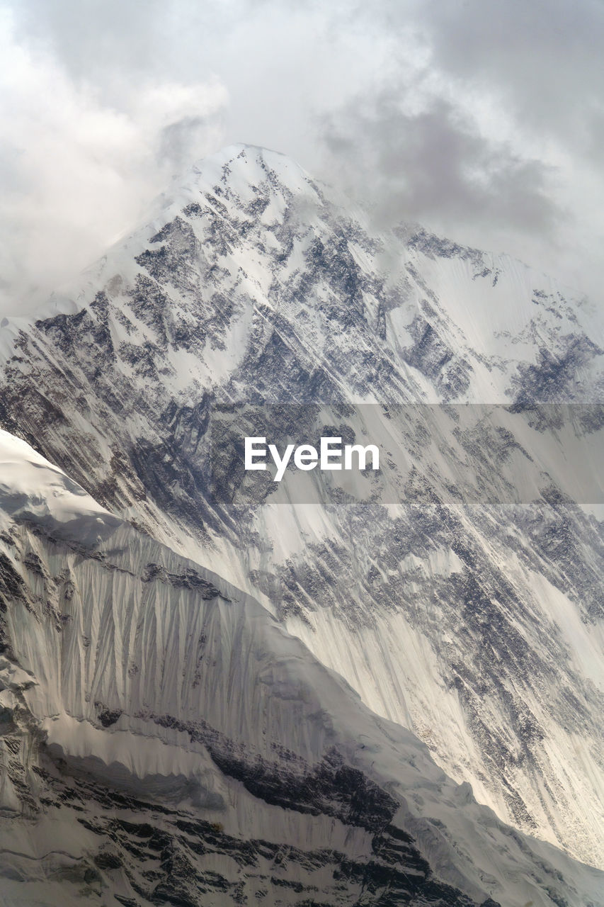 mountain, environment, snow, cold temperature, landscape, scenics - nature, winter, beauty in nature, cloud, snowcapped mountain, mountain range, sky, nature, ice, travel destinations, no people, glacier, travel, non-urban scene, extreme terrain, tranquility, tranquil scene, outdoors, land, frozen, ridge, tourism, plateau, day, mountain peak, cirque, physical geography, geology, awe, idyllic, social issues, polar climate, rock
