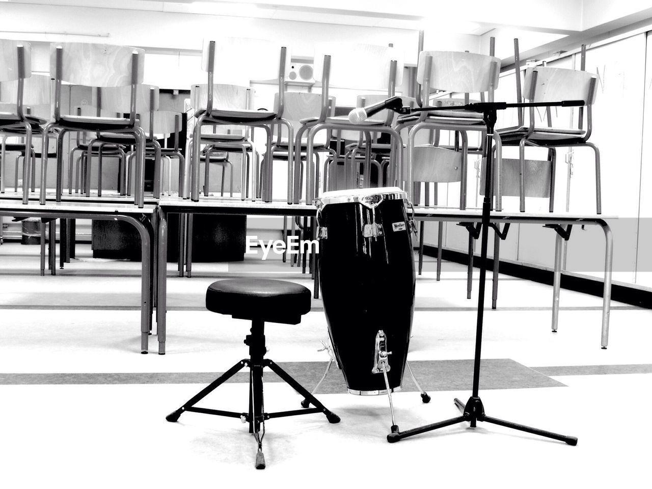 Conga and microphone with stool in empty classroom