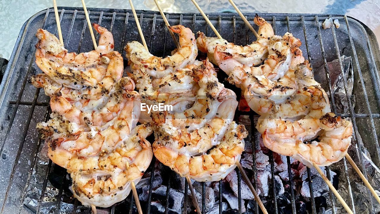 HIGH ANGLE VIEW OF MEAT COOKING ON BARBECUE