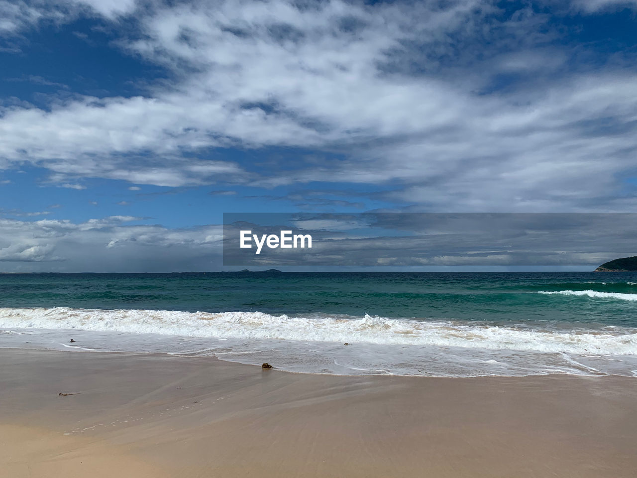 SCENIC VIEW OF SEA SHORE AGAINST SKY