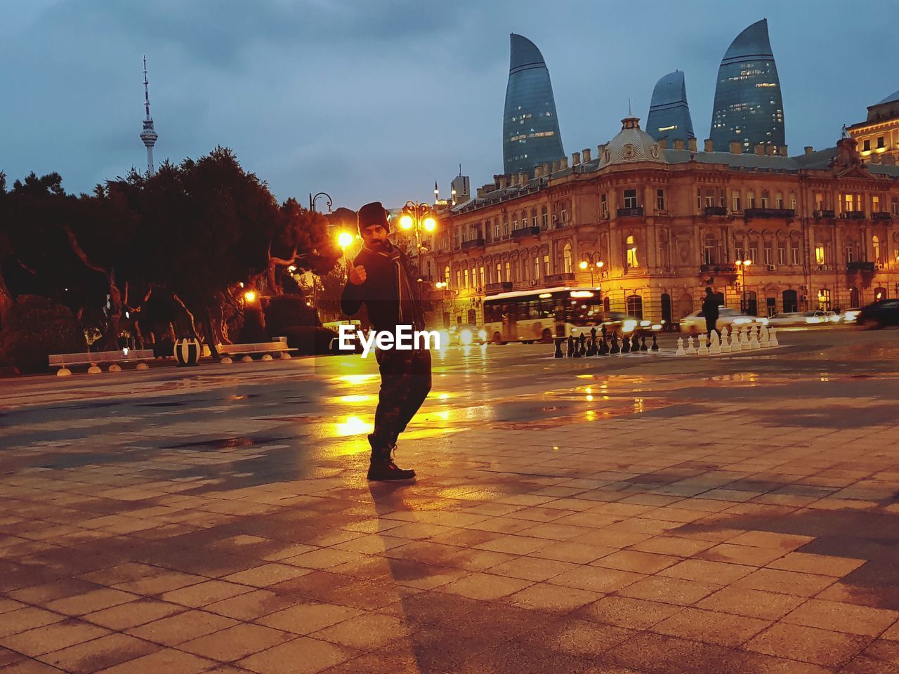 PEOPLE ON ILLUMINATED STREET AT NIGHT