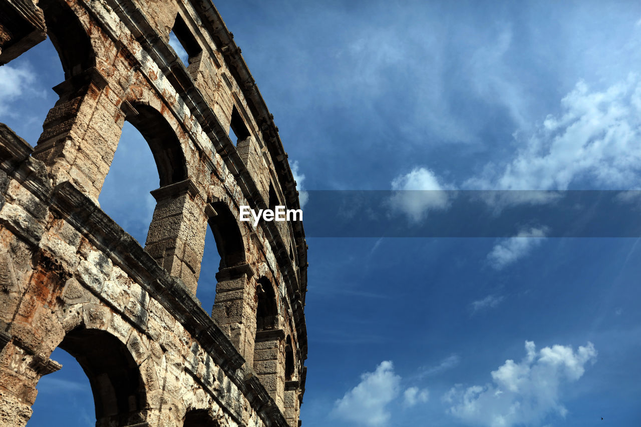 Low angle view of coliseum against sky