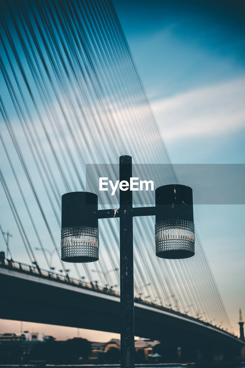 Low angle view of road signal against sky