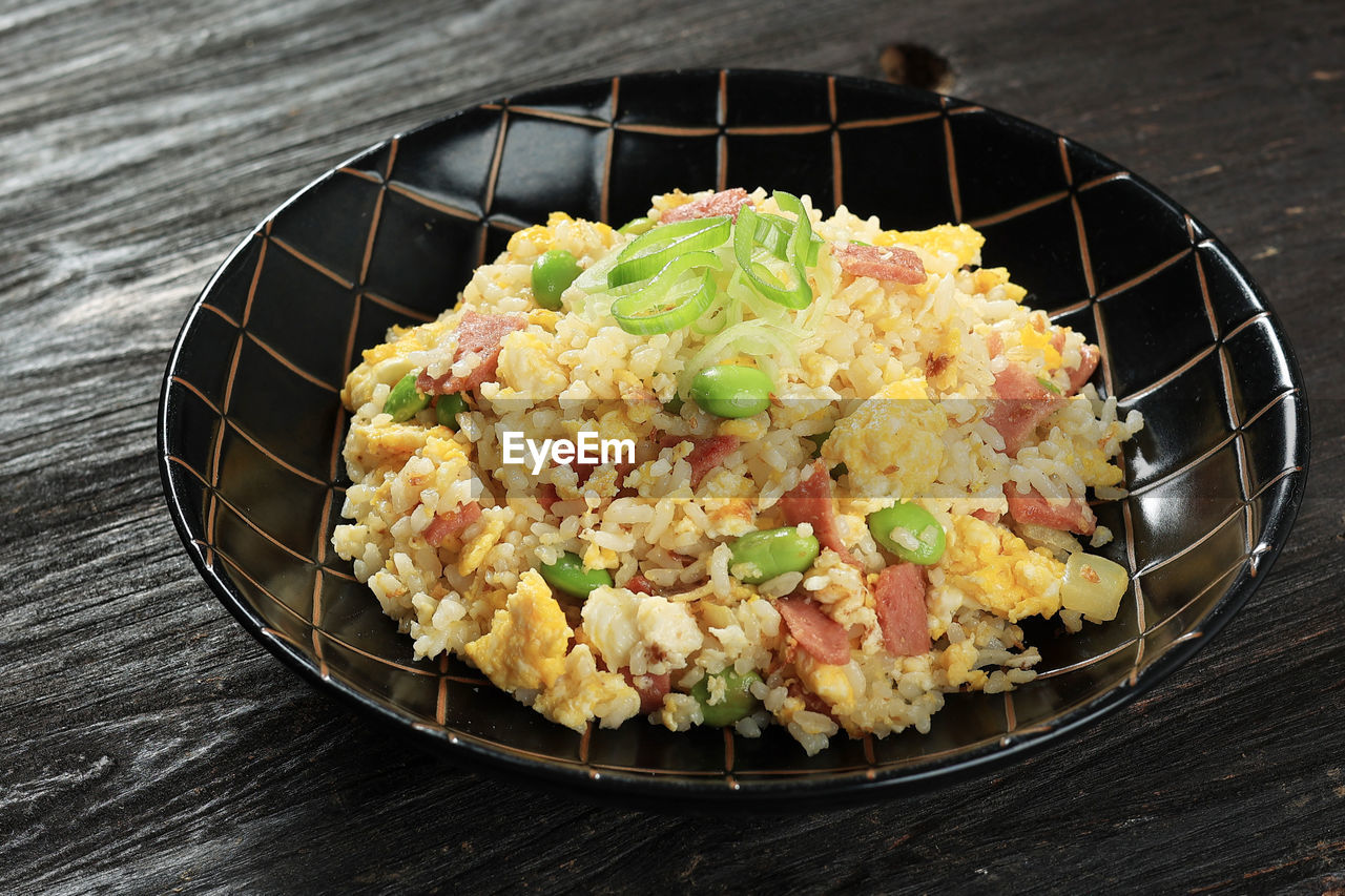 Yakimeshi, japanese fried rice with soy sauce and various topping. close up