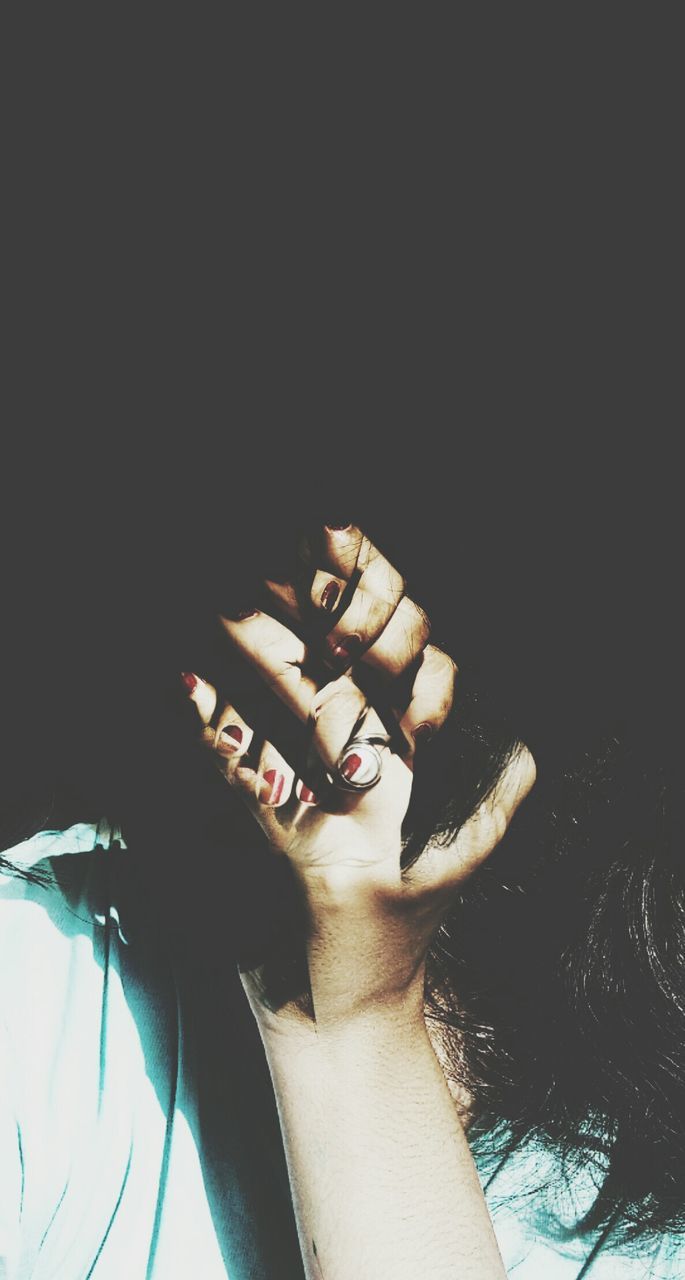 CLOSE-UP PORTRAIT OF WOMAN HAND ON BLACK BACKGROUND