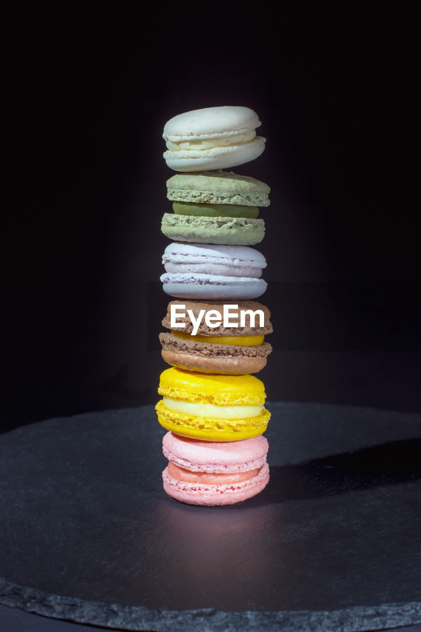 Macarons tower on black background