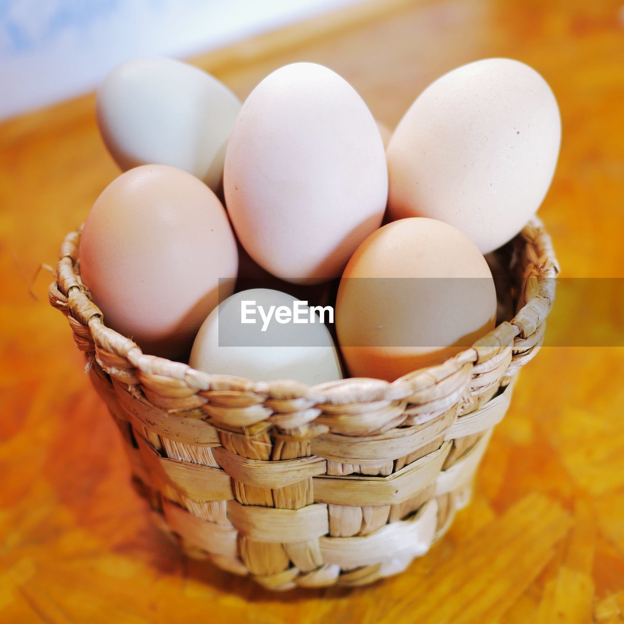 CLOSE-UP OF EGGS IN BASKET ON TABLE