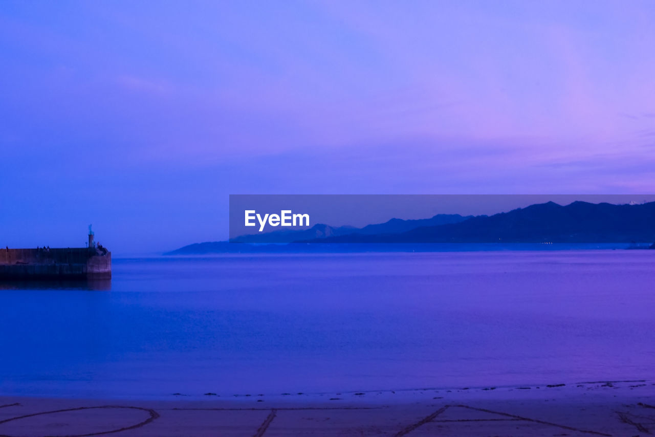 Scenic view of sea against sky at sunset