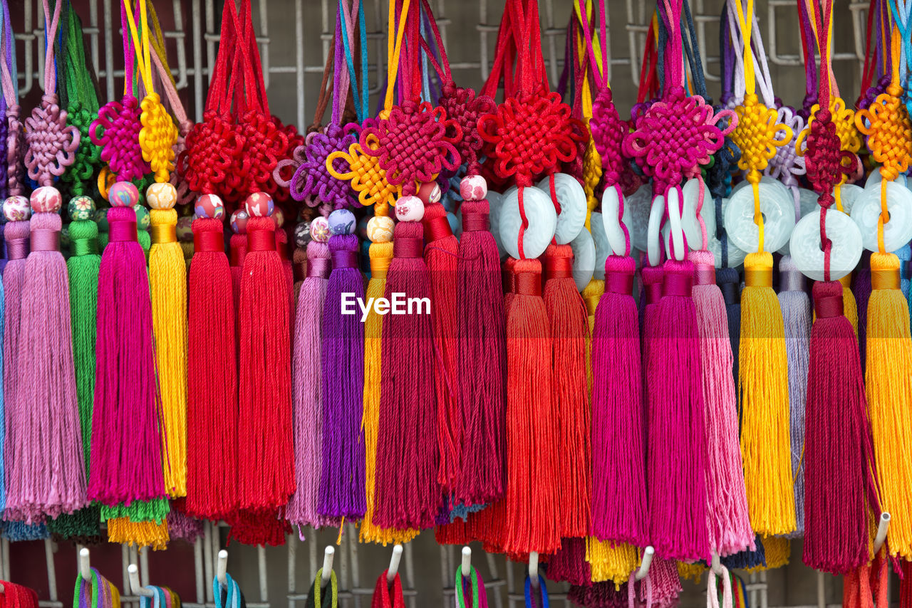 Close-up of multi colored decoration hanging for sale in market