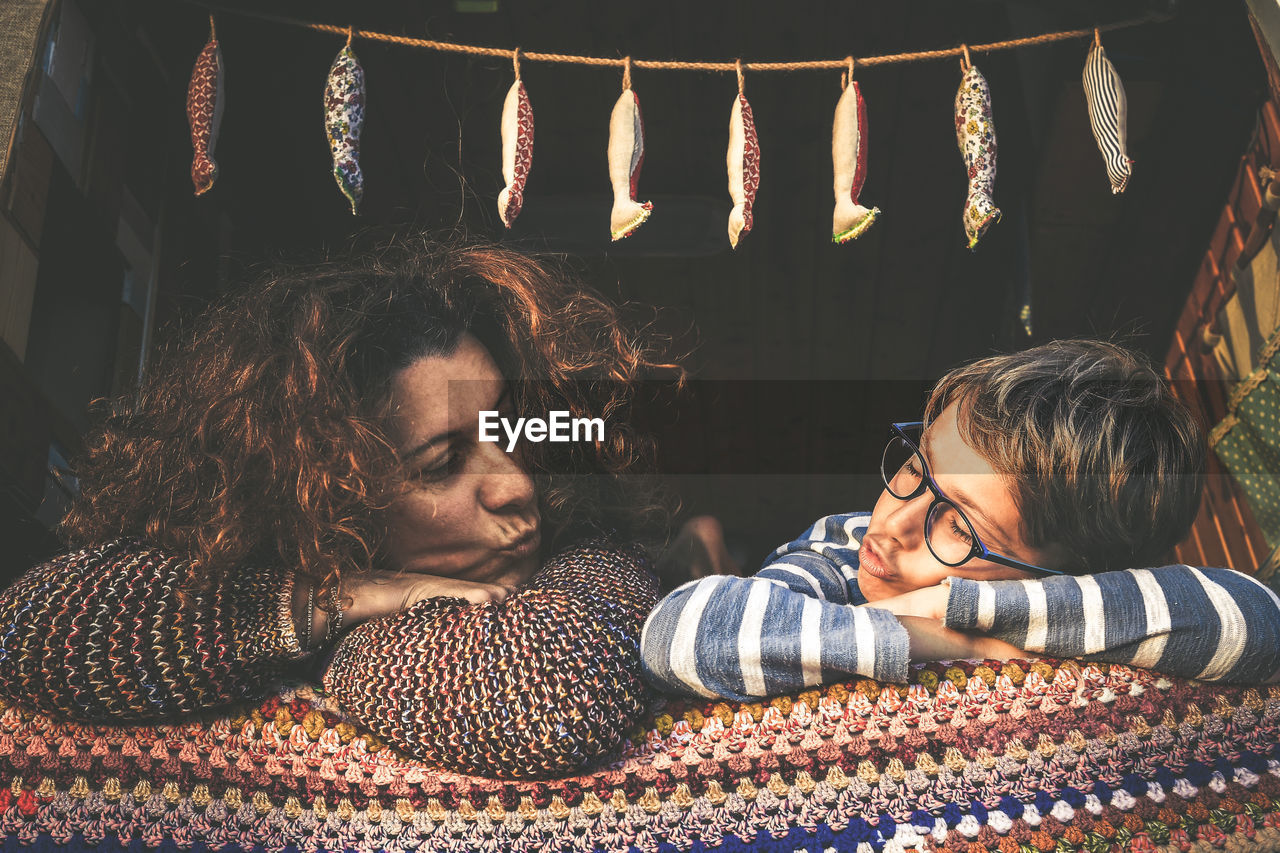 Mother and son puckering while lying on sofa