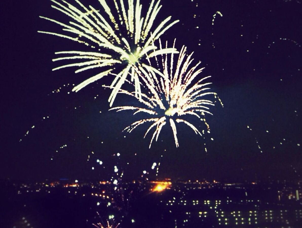 LOW ANGLE VIEW OF FIREWORK DISPLAY AT NIGHT