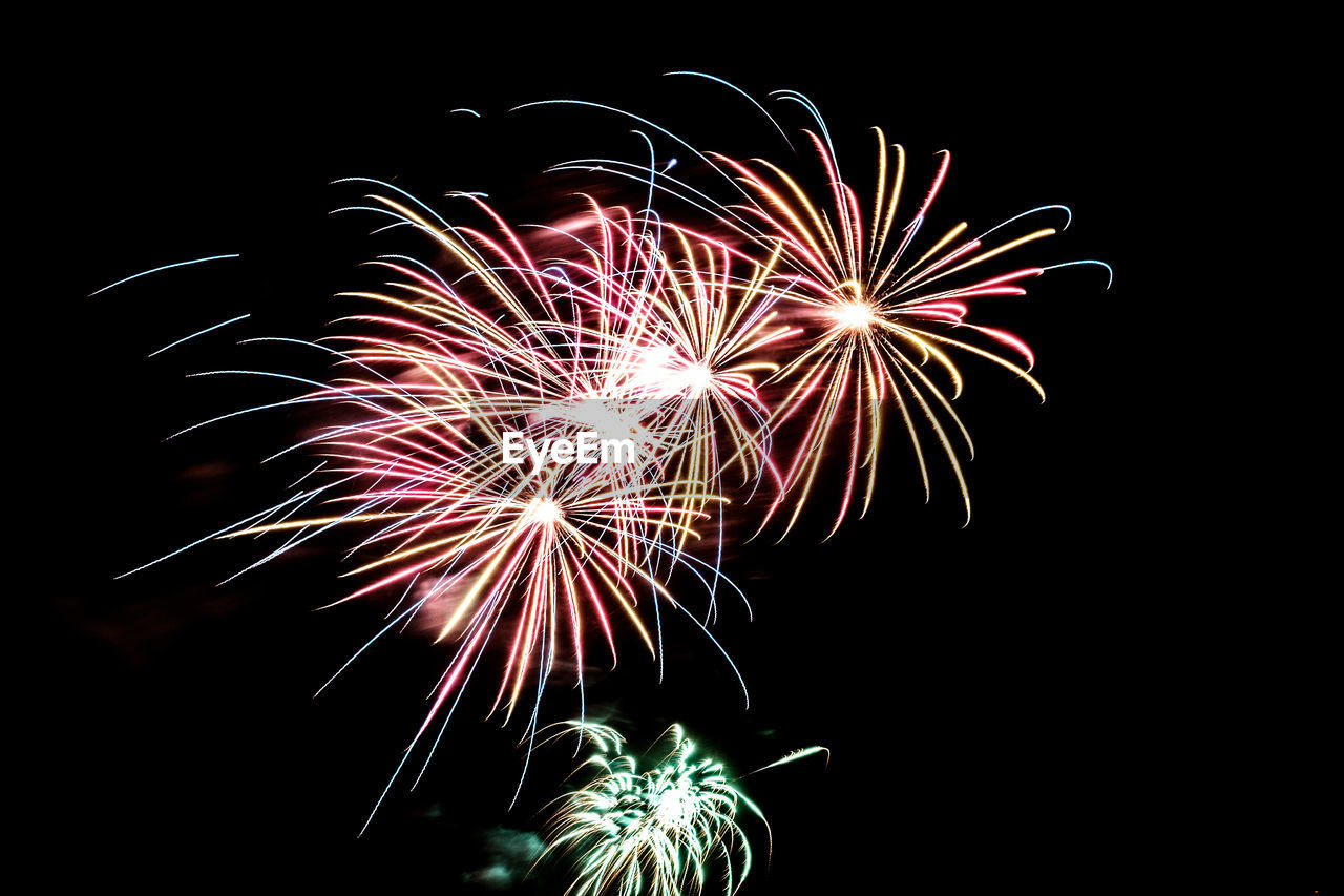 LOW ANGLE VIEW OF FIREWORK DISPLAY AGAINST SKY