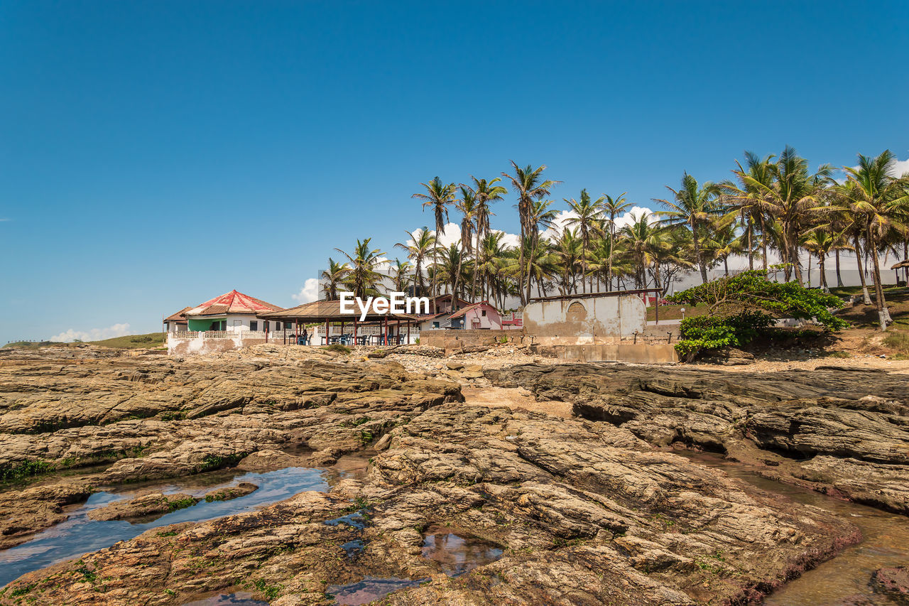 Tropical coast of accra when time the water has left the coast and the cliffs emerge