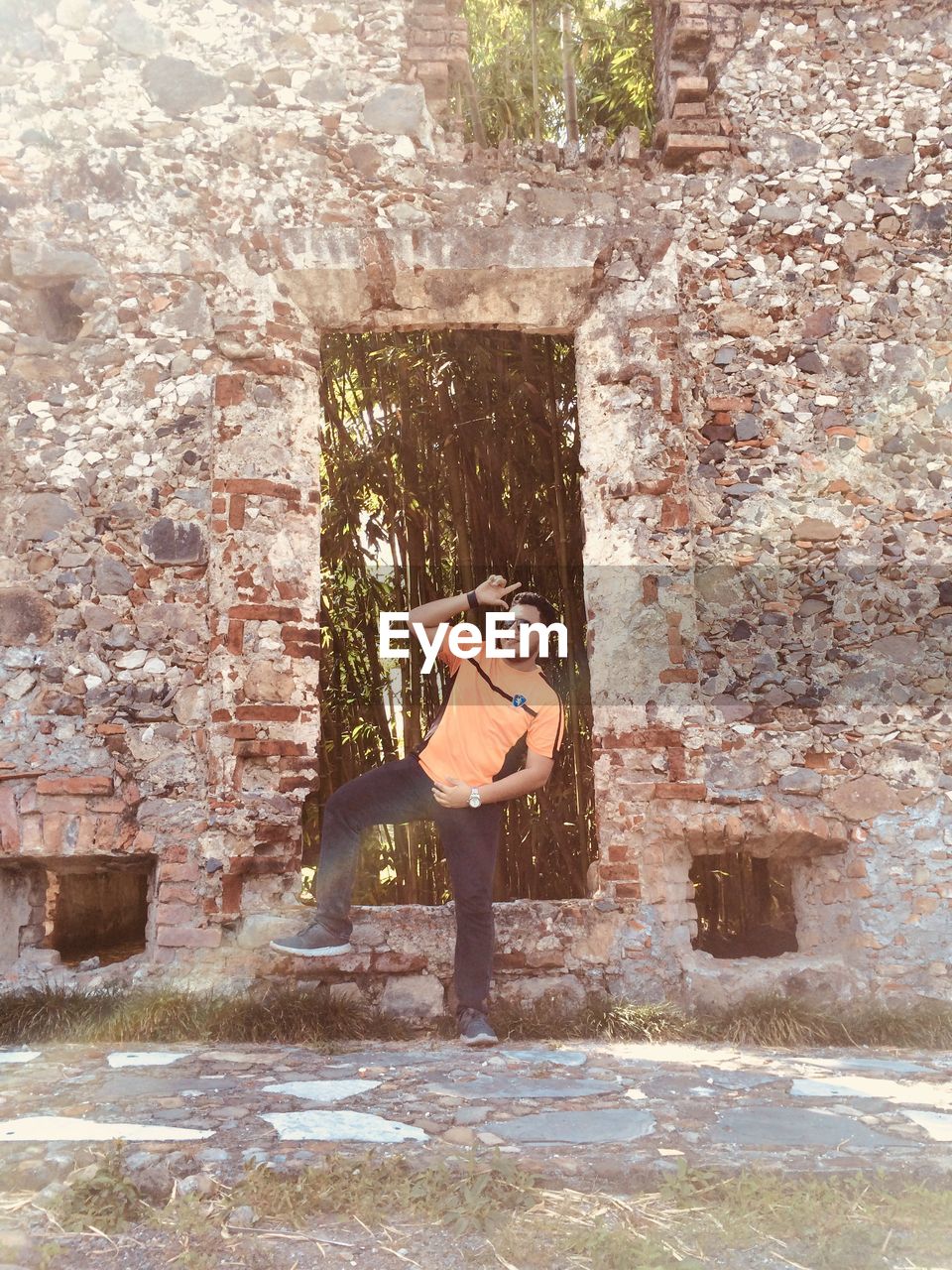 WOMAN STANDING BY BUILDING