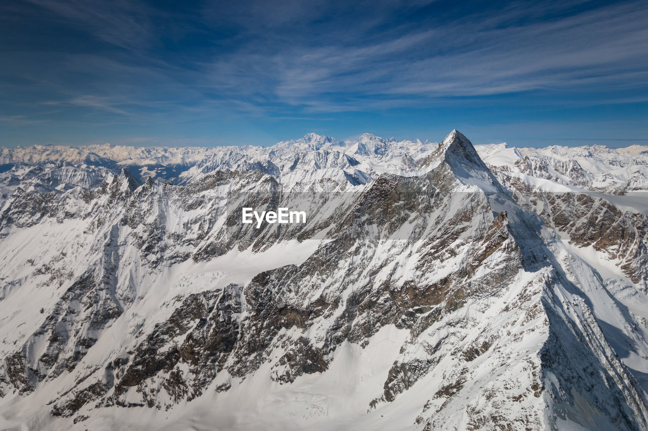 Aerial view of snow covered landscape with mont blanc mountain in italian french alps against blue s