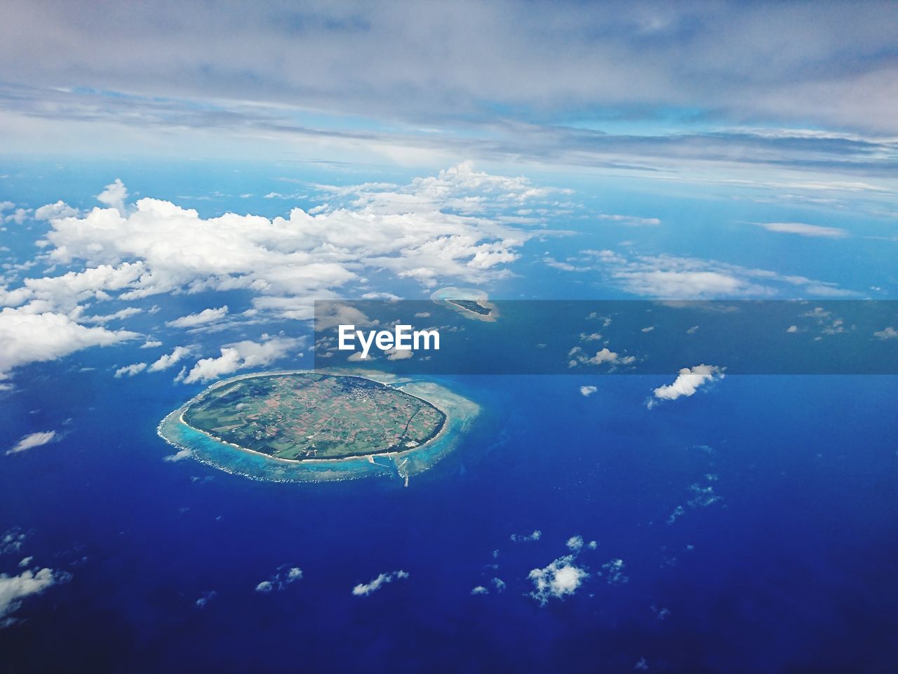 Aerial view of island and sea against sky