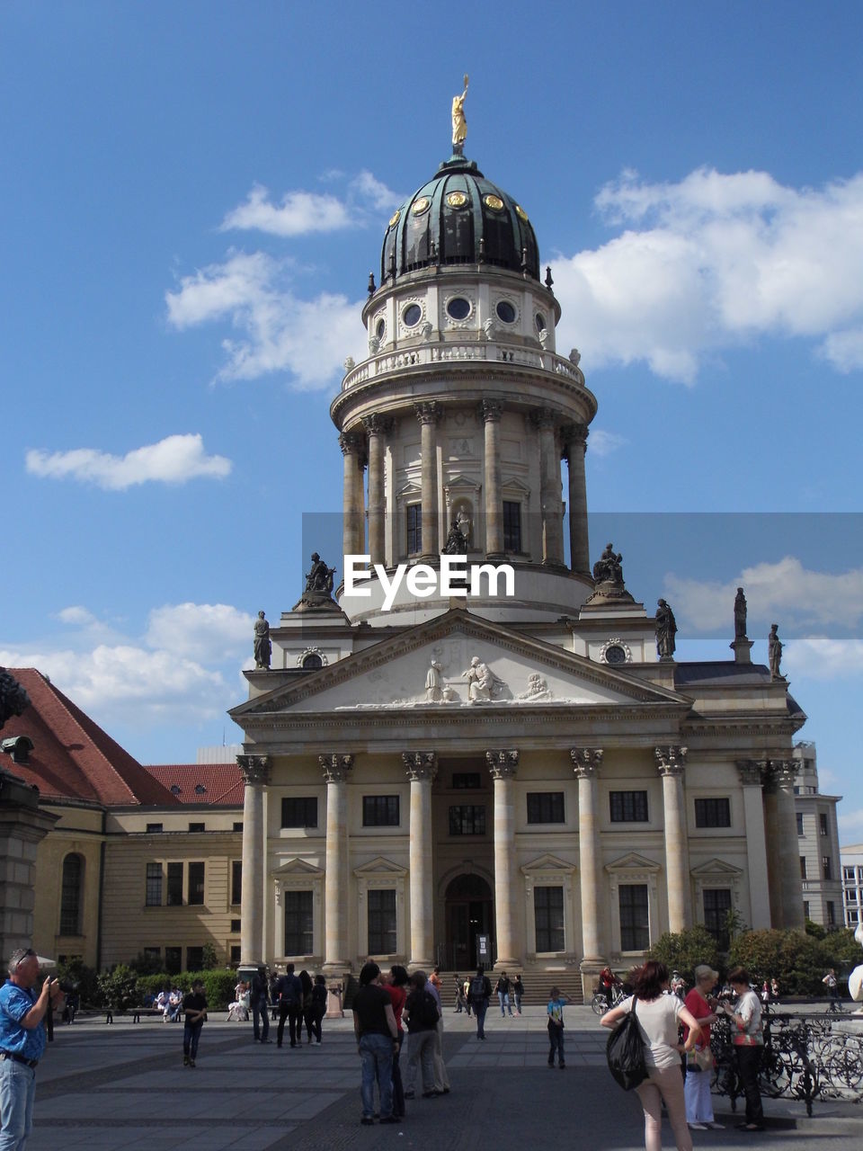 People visiting neue kirche against sky