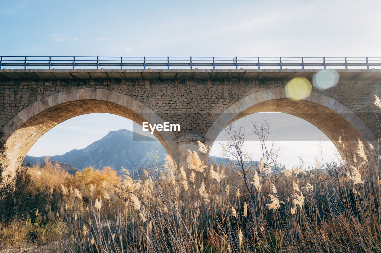 Low angle view of arch bridge against sky