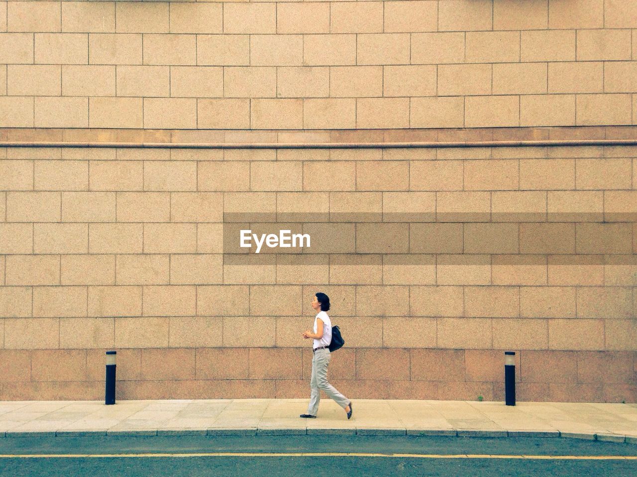 Woman walking on footpath