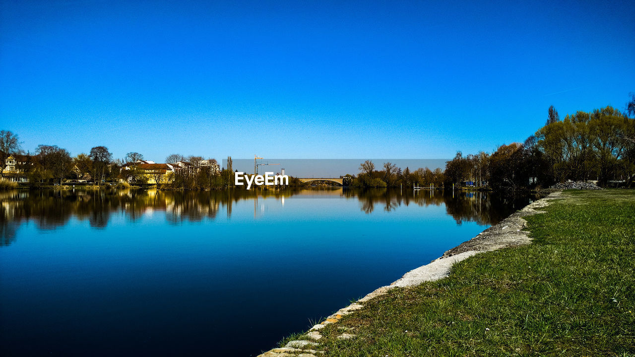 SCENIC VIEW OF LAKE AGAINST BLUE SKY