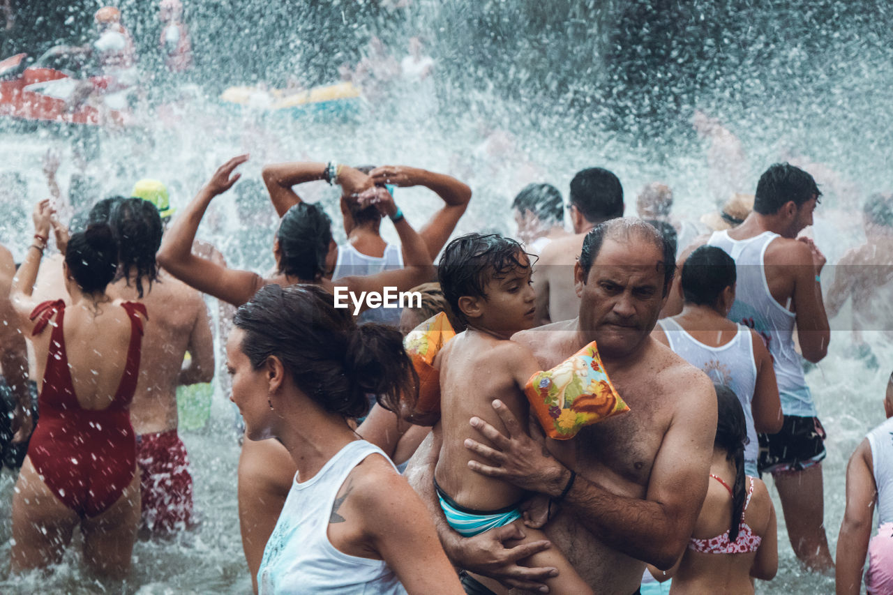 GROUP OF PEOPLE IN SWIMMING POOL