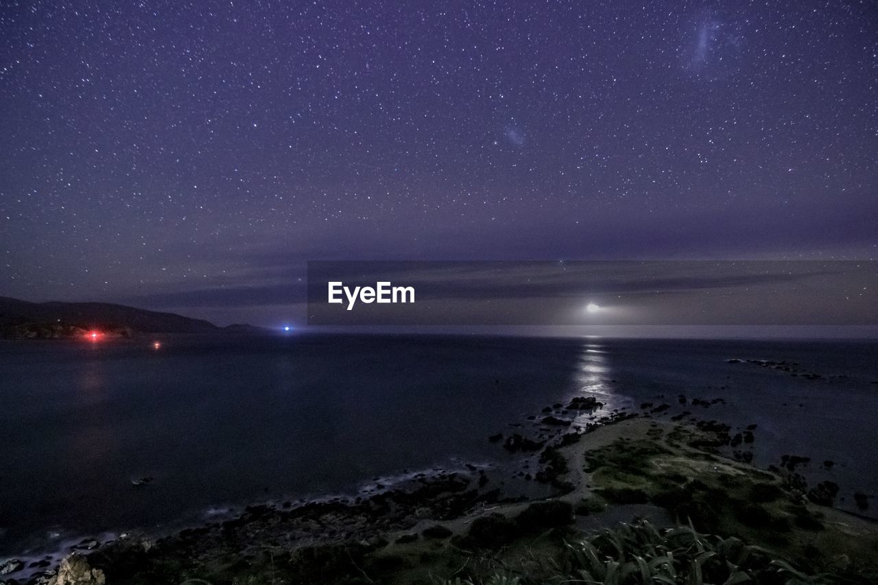 Scenic view of sea against sky at night